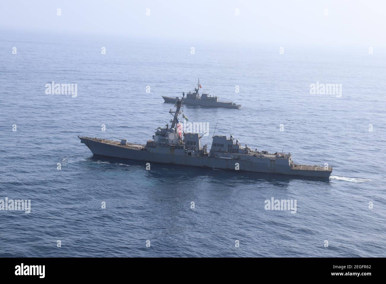 A U.S. Navy Arleigh Burke-class guided-missile destroyer USS James E. Williams, bottom, conducts a passing exercise with the Colombian naval frigate ARC Antioquia during joint operations February 15, 2021 in the Caribbean Sea. Stock Photo