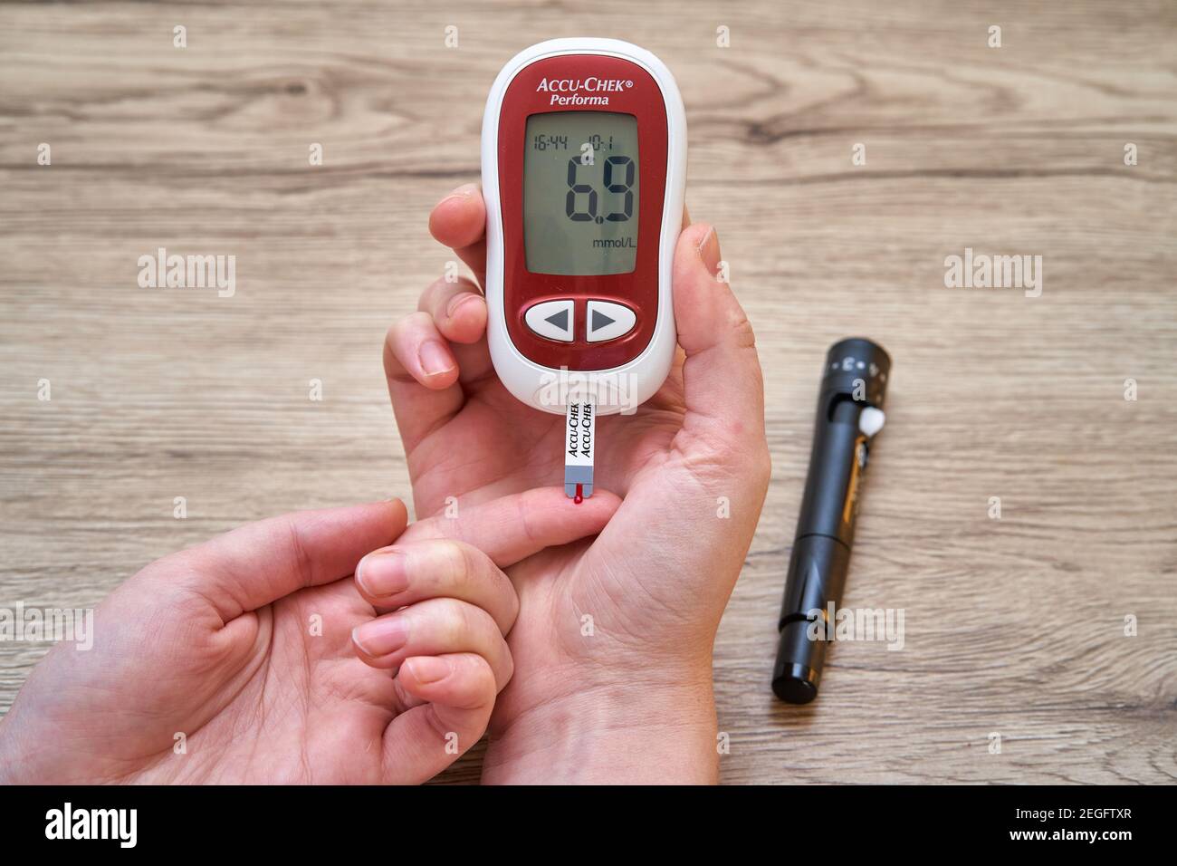 Measuring blood sugar with glucometer at home. High blood sugar measurement Stock Photo