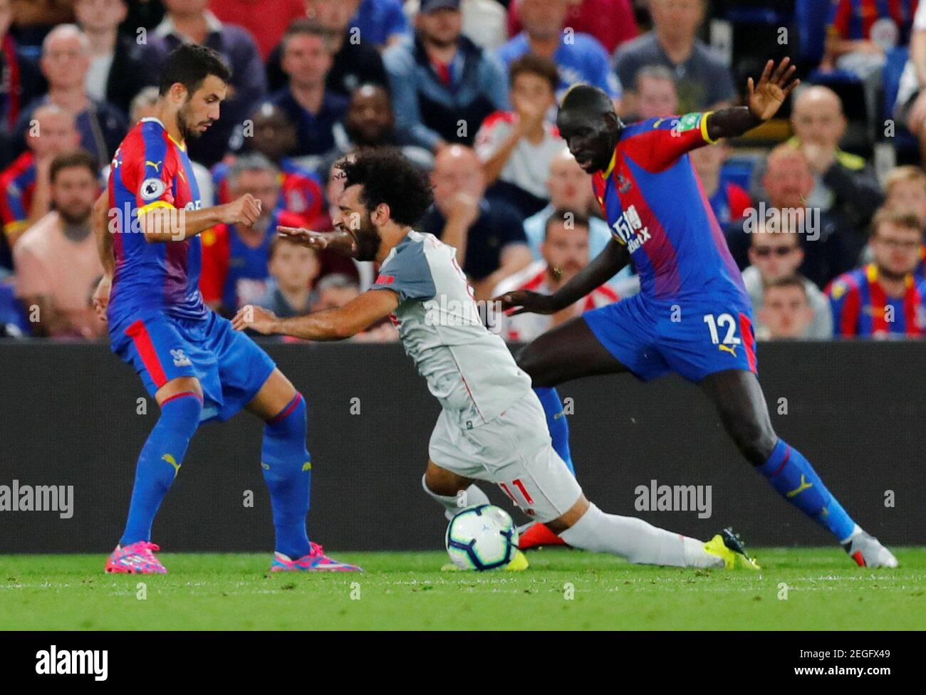 Soccer Football - Premier League - Crystal Palace v Liverpool - Selhurst Park, London, Britain - August 20, 2018  Crystal Palace's Mamadou Sakho concedes a penalty against Liverpool's Mohamed Salah                    REUTERS/Eddie Keogh  EDITORIAL USE ONLY. No use with unauthorized audio, video, data, fixture lists, club/league logos or "live" services. Online in-match use limited to 75 images, no video emulation. No use in betting, games or single club/league/player publications.  Please contact your account representative for further details. Stock Photo