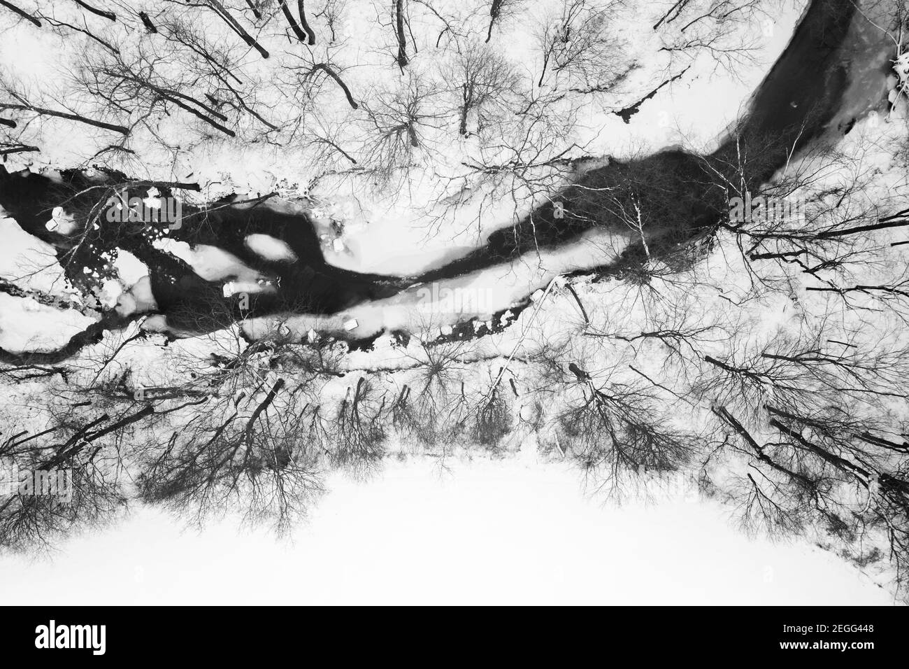 A black and white image of Gurthrie creek in Jackson County, IN choked with ice and flanked by lots of snow.  Shot from a drone looking straight down. Stock Photo