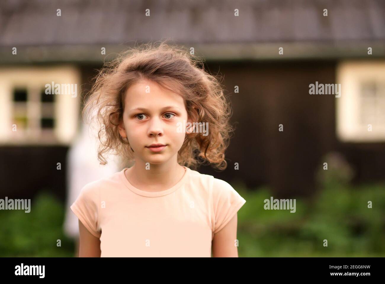Portrit of happy smiling little girl on the house building background in countryside Stock Photo
