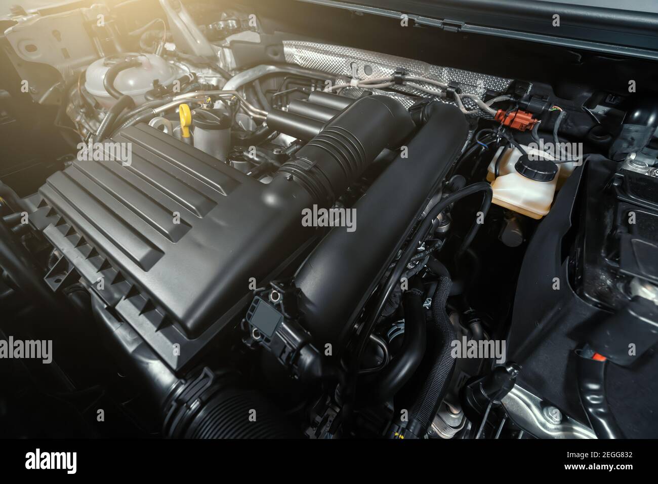 Modern turbocharged eco-friendly engine or motor under vehicle hood close up. Stock Photo