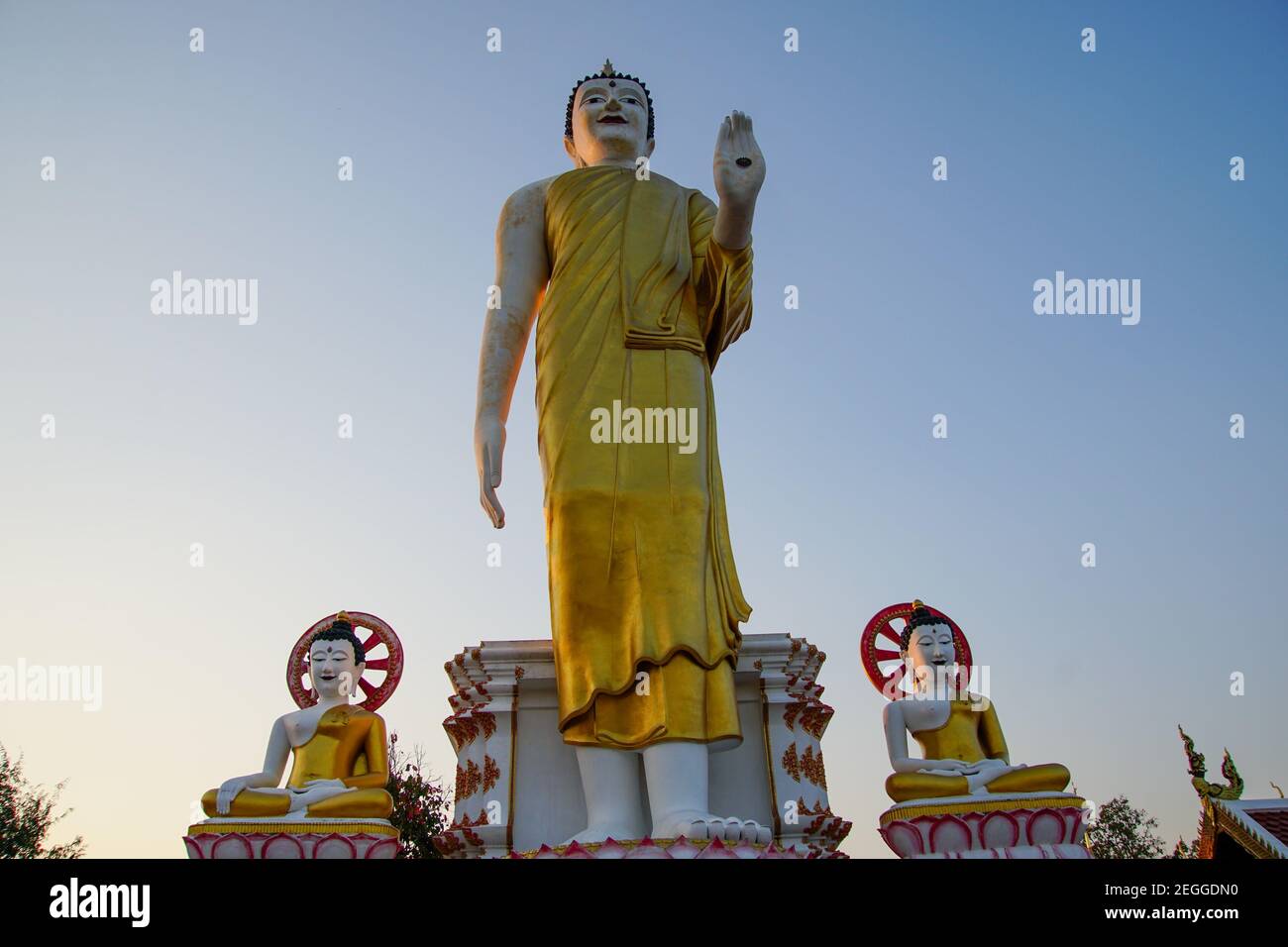 Low angle shot of a big statue of Buddha under the sunlight and a blue ...