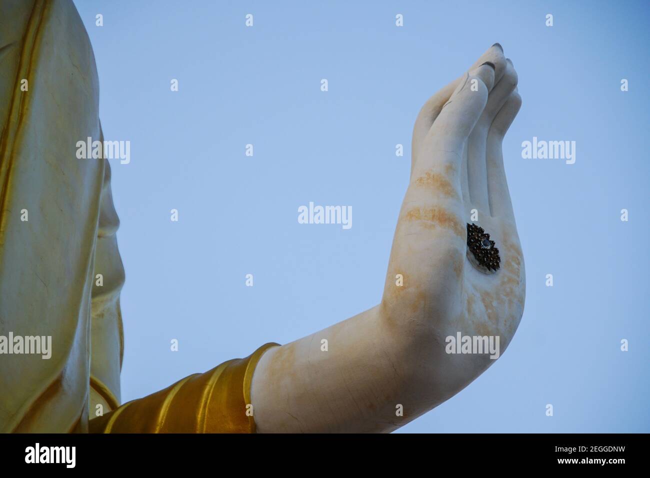 Low angle shot of a big statue of Buddha's hand under the sunlight and ...