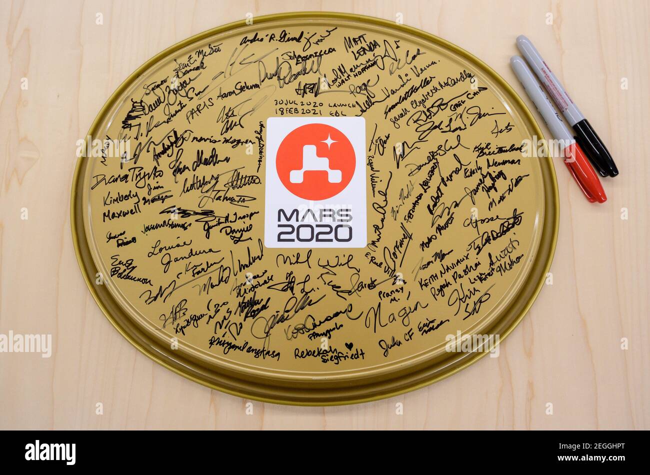 A serving tray with signatures from the NASA Perseverance Mars rover team is seen in mission control, Thursday, Feb. 18, 2021, at NASA's Jet Propulsion Laboratory in Pasadena, California. A key objective for Perseverance's mission on Mars is astrobiology, including the search for signs of ancient microbial life. The rover will characterize the planet's geology and past climate, pave the way for human exploration of the Red Planet, and be the first mission to collect and cache Martian rock and regolith. Photo Credit: (NASA/Bill Ingalls) Please note: Fees charged by the agency are for the agenc Stock Photo