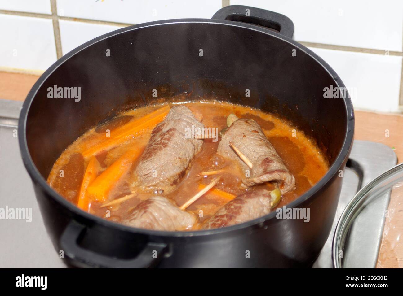 cooking beef roulade in sauce. german beef rolls in pot. Stock Photo