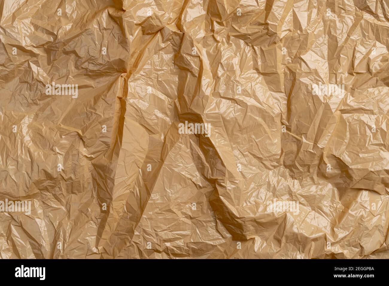 Textured crumpled wrinkled garbage plastic bag. Brown abstract ...