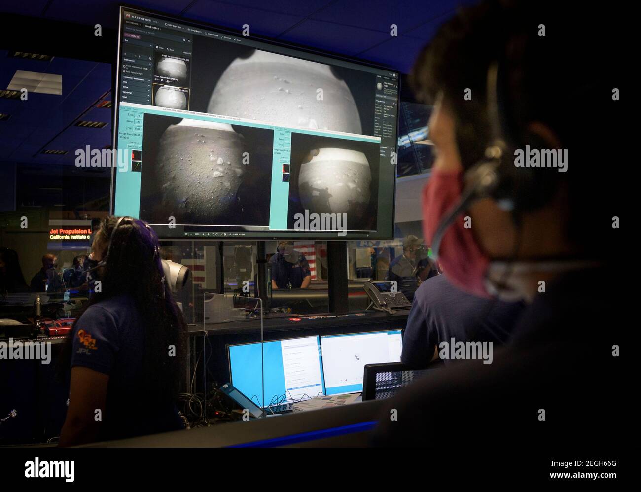 Pasadena, United States Of America. 18th Feb, 2021. Members of the NASA Perseverance Mars rover mission team watch monitors as the first images arrive moments after the spacecraft successfully touched down on the surface of the Red Planet at the NASA Jet Propulsion Laboratory February 18, 2021 in Pasadena, California. Credit: Planetpix/Alamy Live News Stock Photo