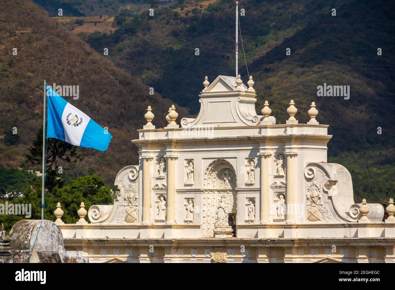 A view of the Guatemalan flag in front of St. James Cathedral San Joseph Parish in Antigua, Guatemala Stock Photo