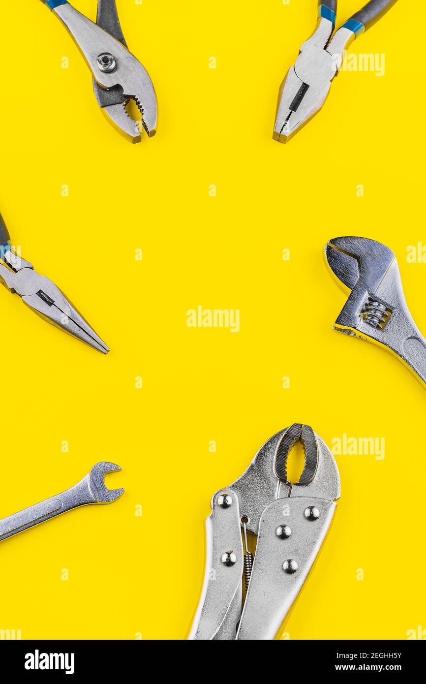 View of some neat work tools on a yellow background Stock Photo