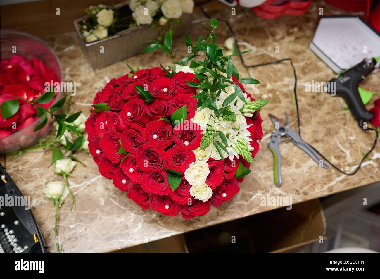 Flower box with red roses and white flowers on the table, flower box