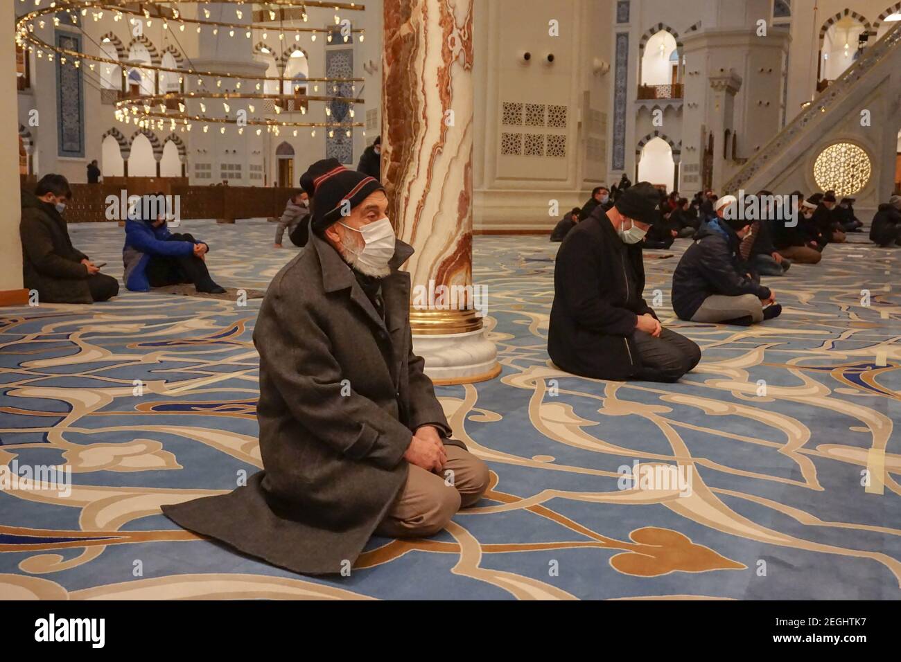 An old man waiting for prayers during the commemoration at the Grand