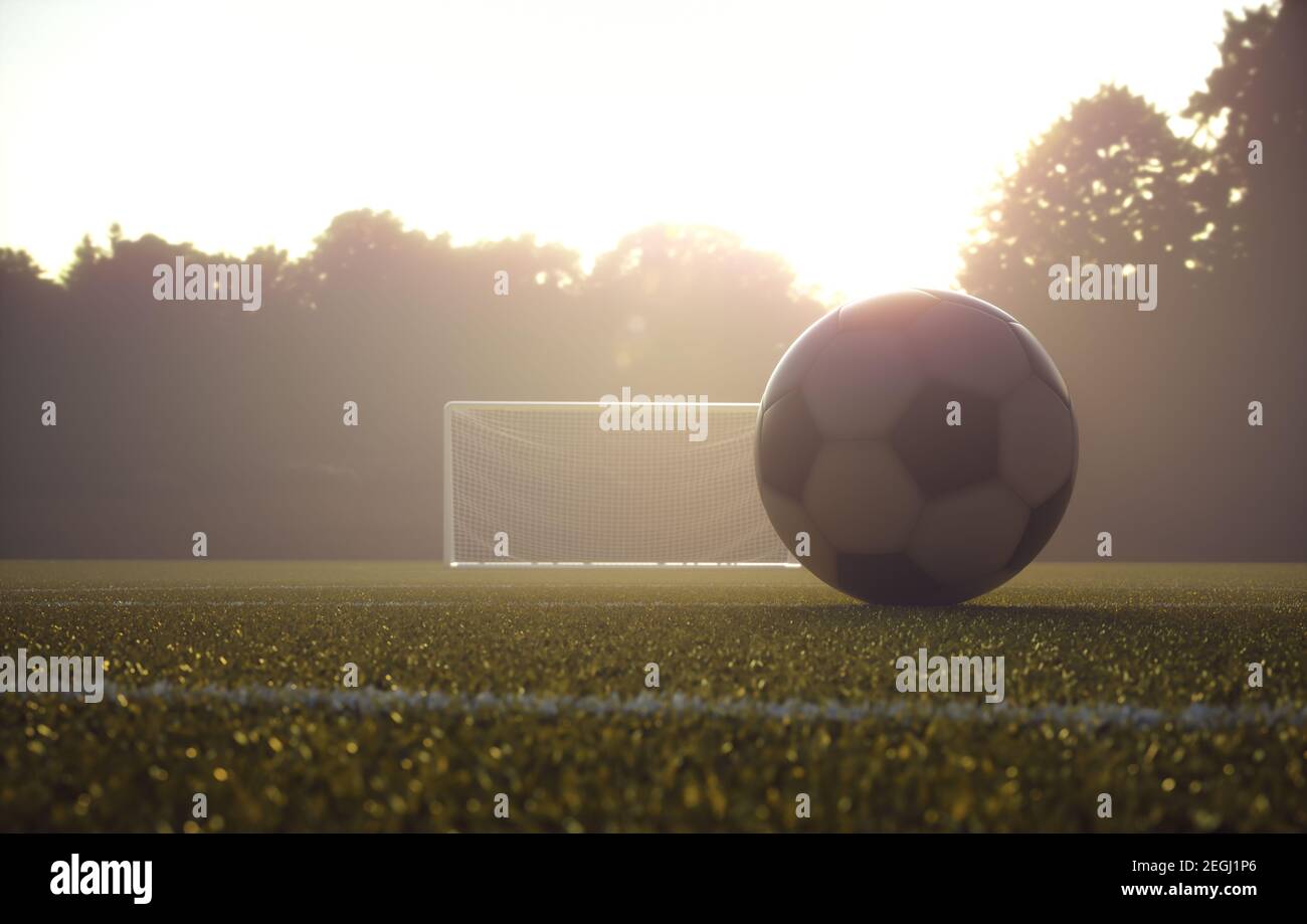 Soccer ball on the field with the sunset in the background. Depth of field with focus on the ball. Stock Photo