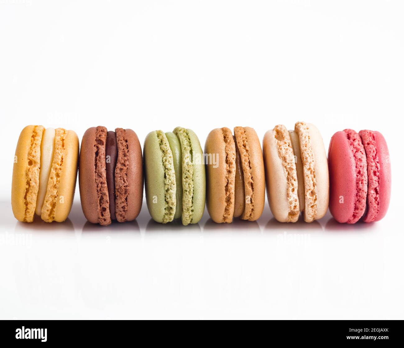 Colorful Macarons in a row on white background Stock Photo - Alamy