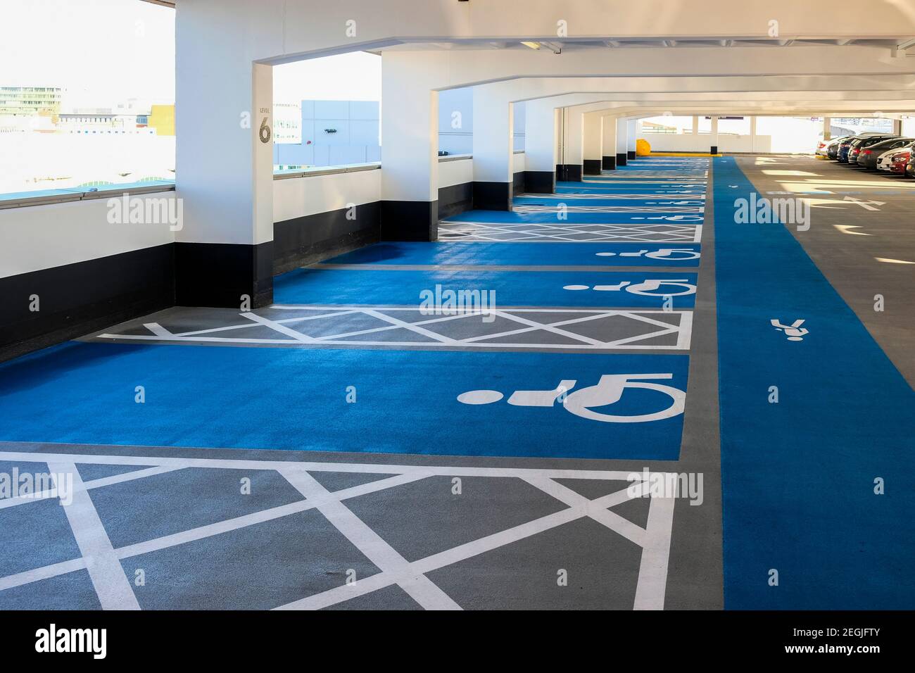 Disabled parking bays and pedestrian walkway in a multi storey car park Stock Photo