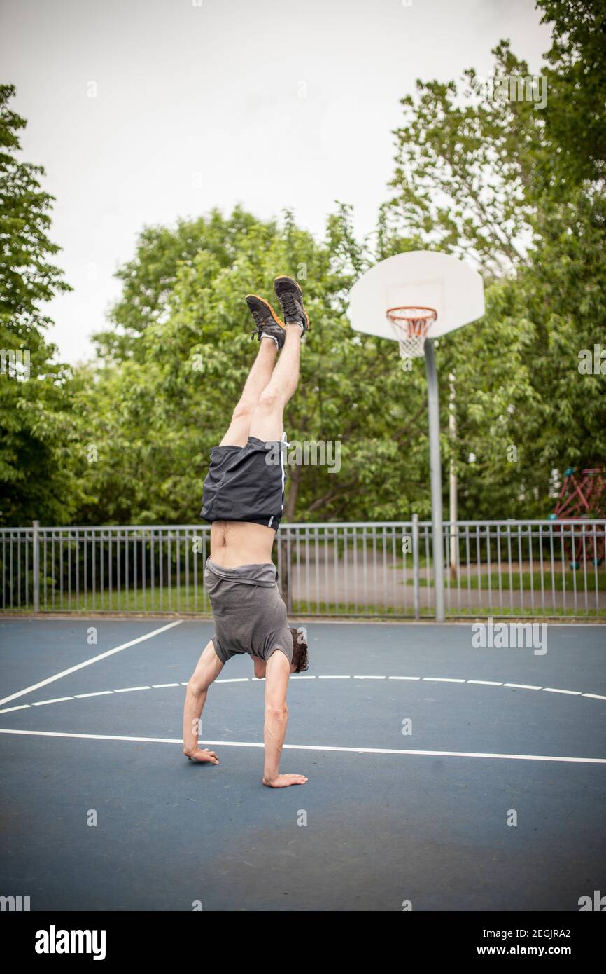 Man doing a handstand on basketball court, Montreal, Quebec, Canada Stock  Photo - Alamy