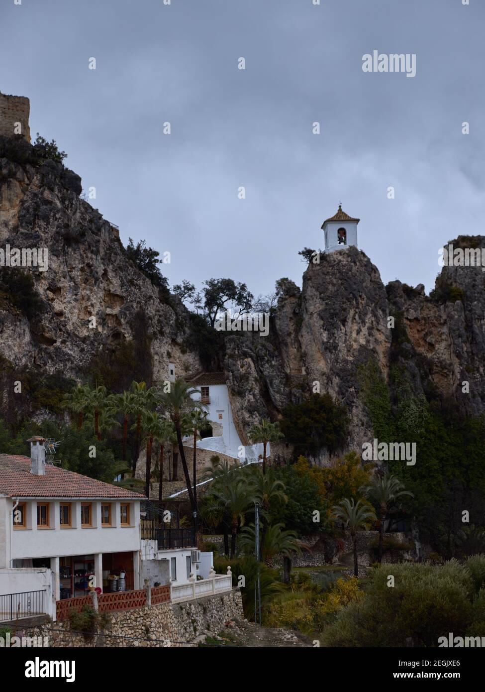 religious chapel on top of a mountain, belonging to the castle of Guadalest in the province of Alicante, Spain. scenery surrounded by palm trees Stock Photo