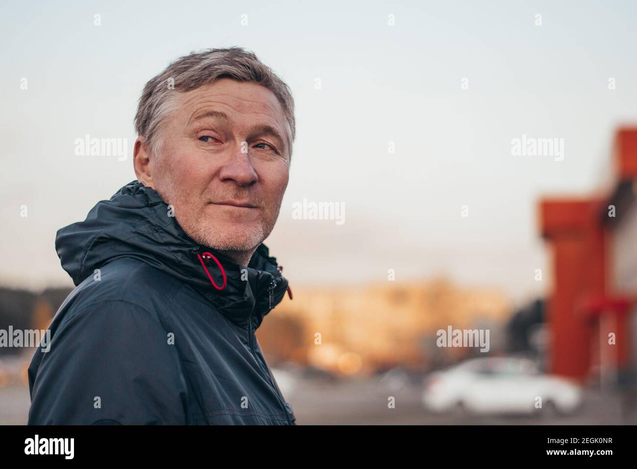 Portrait of a handsome middle-aged man. Adult man in a jacket outdoors in the city. Blurred background. Copy space. Stock Photo