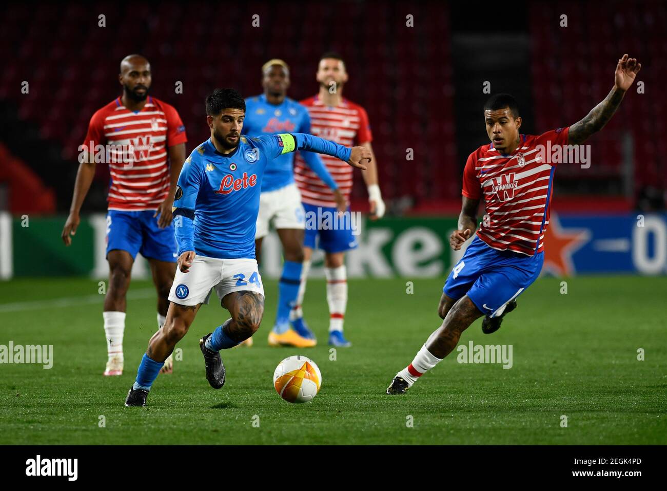 SSC Napoli Lorenzo Insigne and Granda CF player Robert Kenedy are seen in action during the Uefa Europa League round of 16 match between Granada CF and SSC Napoli at Nuevo Los Carmenes Stadium. Stock Photo