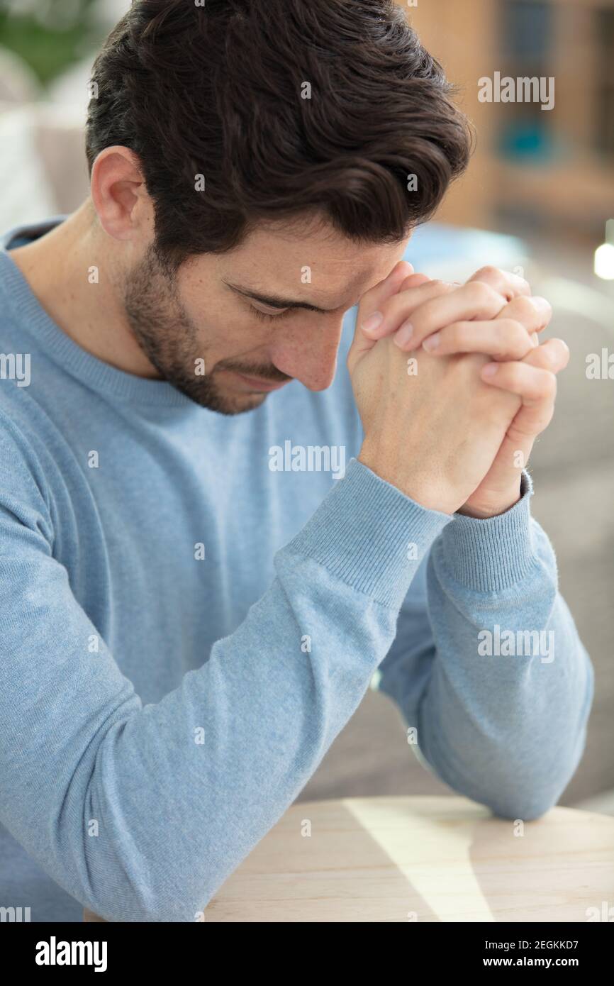 handsome man in depression with hand on forehead Stock Photo