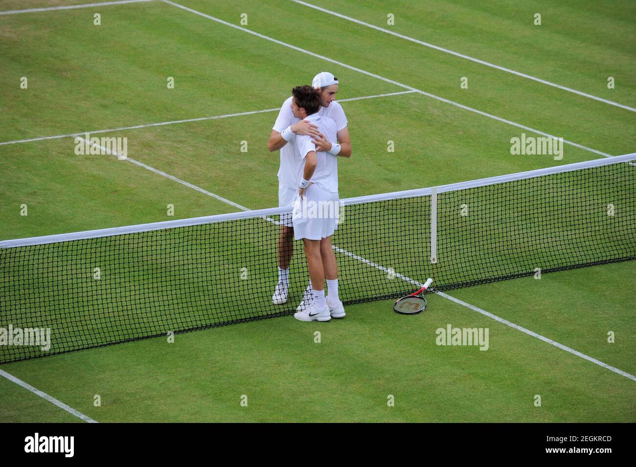 Tennis - Wimbledon - All England Lawn Tennis & Croquet Club, Wimbledon,  England - 24/6/10 John Isner of USA (L) embraces Nicolas Mahut of France  (R) after winning their first round match.