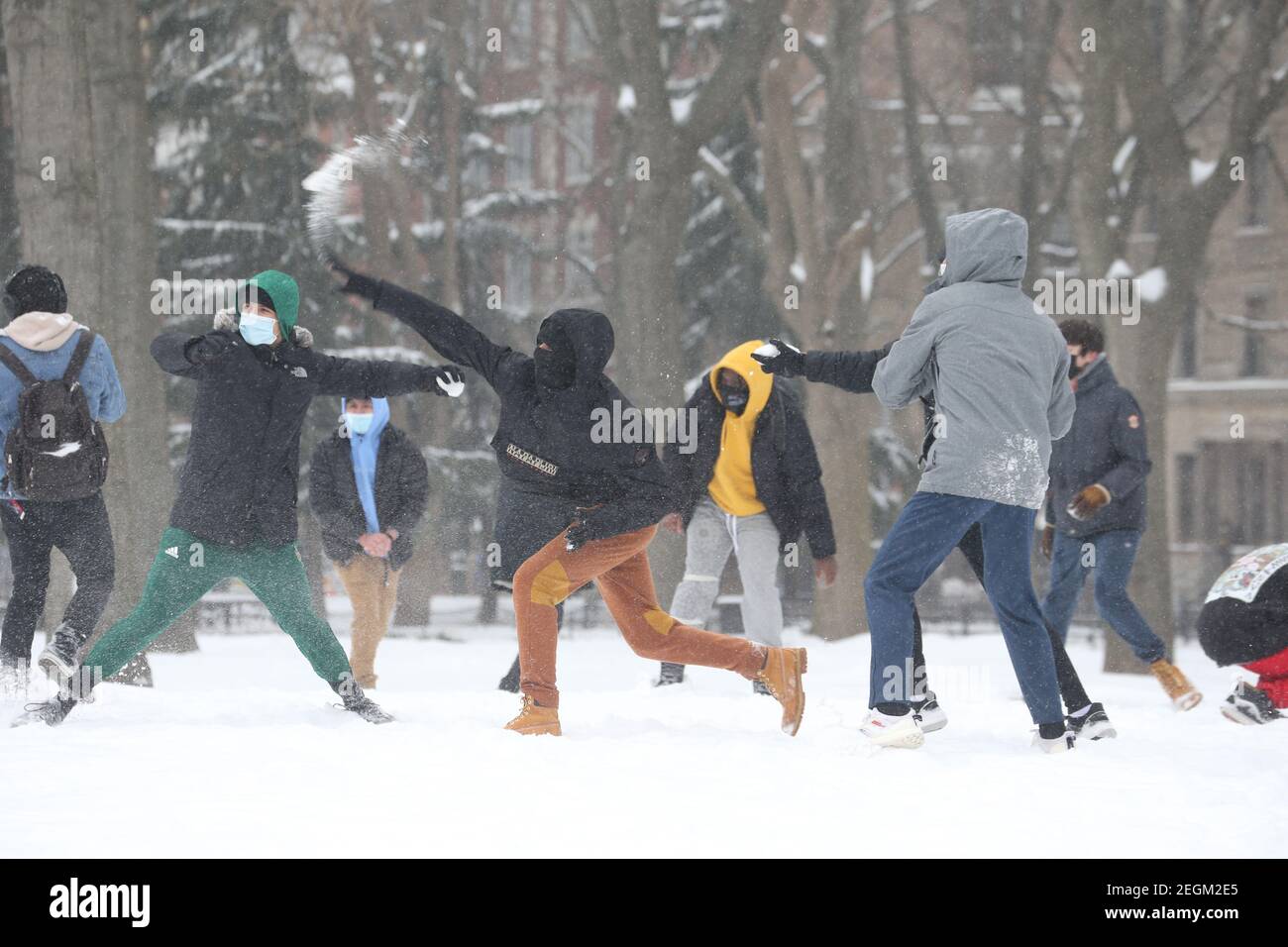 February 18, 2021 :  A light snowstorm hit New York City. A snowball fight in Washington Square Park Stock Photo