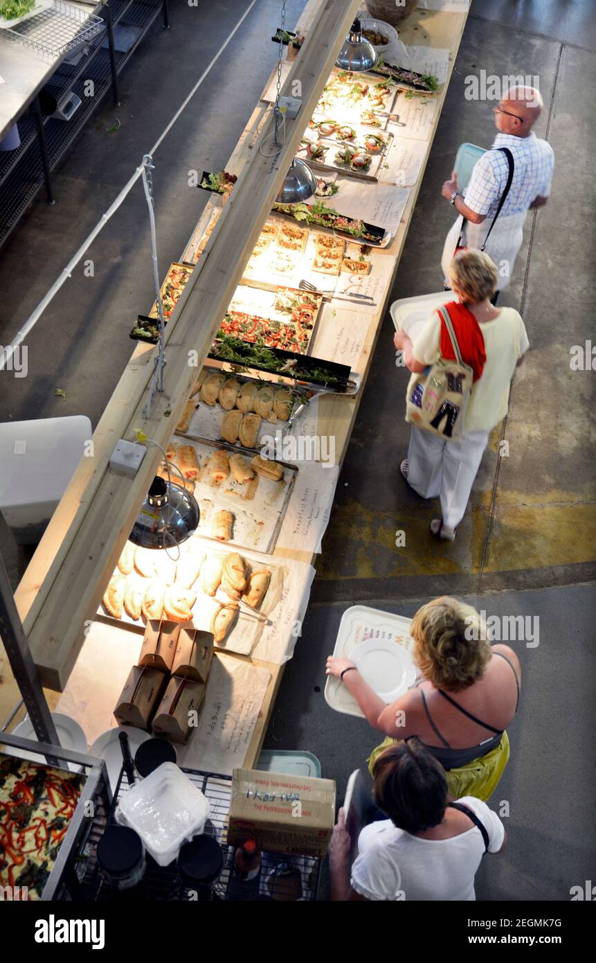 people queuing for food at self service cafe Stock Photo