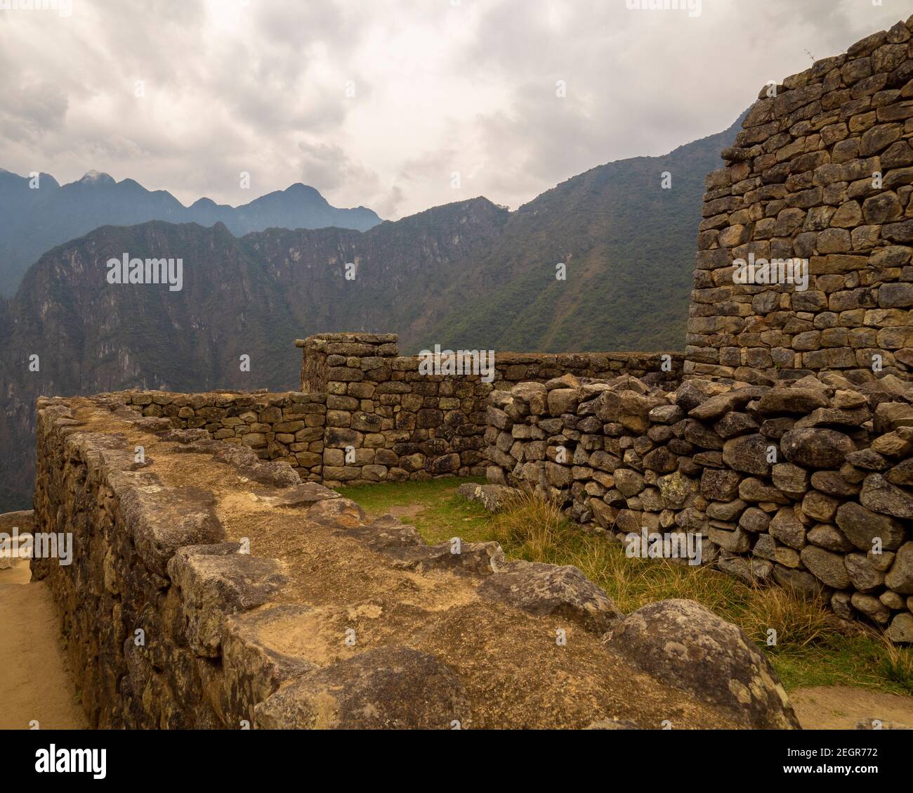 Machu Picchu walls with mountains on the background under a clouded sky ...