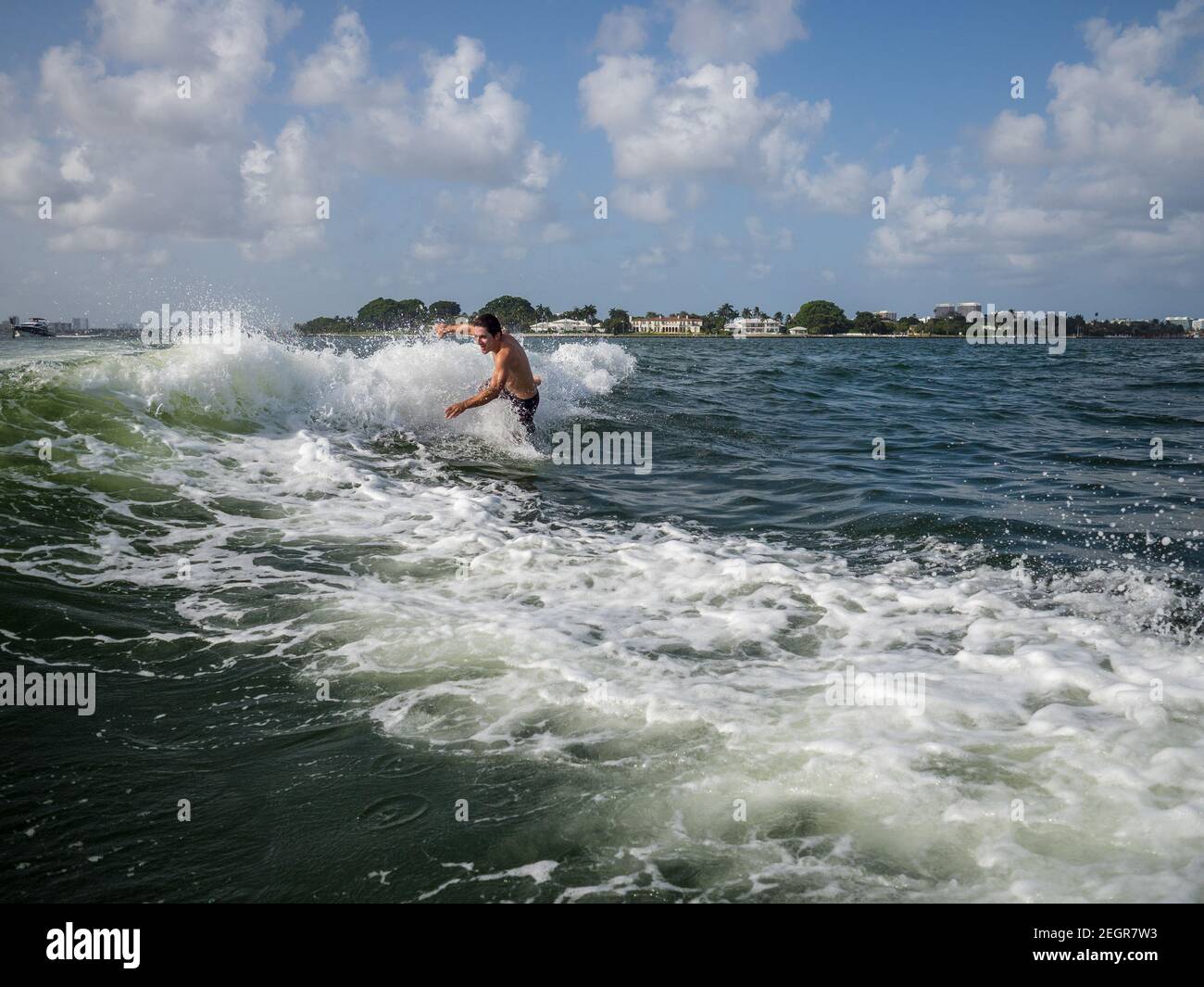 Man loses balance and falls to the water while wakeboarding in Miami Stock Photo