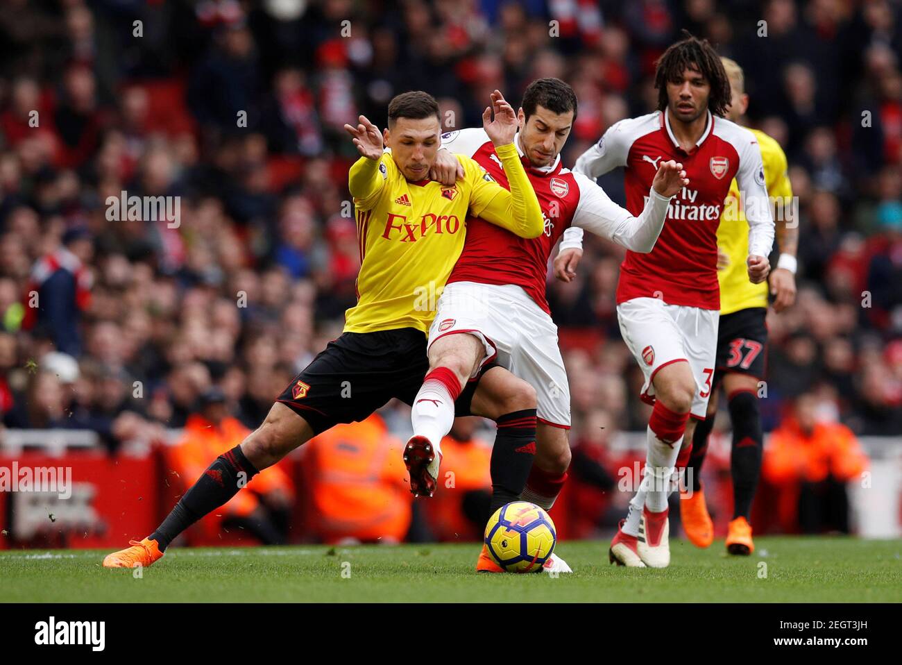 Soccer Football - Premier League - Arsenal vs Watford - Emirates Stadium, London, Britain - March 11, 2018 Arsenal's Henrikh Mkhitaryan in action with Watford's Jose Holebas REUTERS/Eddie Keogh EDITORIAL USE ONLY. No use with unauthorized audio, video, data, fixture lists, club/league logos or "live" services. Online in-match use limited to 75 images, no video emulation. No use in betting, games or single club/league/player publications. Please contact your account representative for further details. Stock Photo