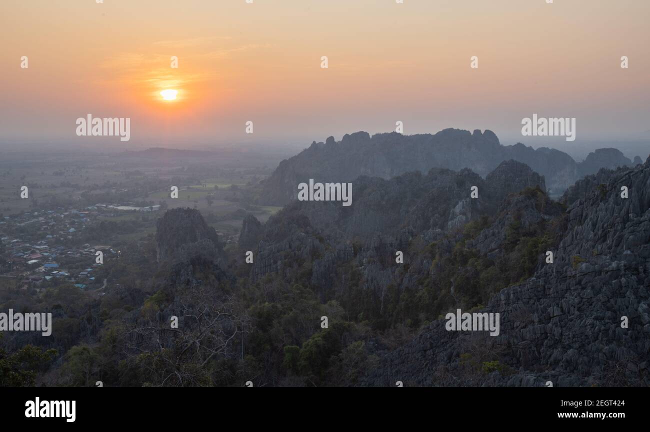 This is the photo of limstone mountain in Pisanulok Thailand during Sunset in rural area, the view is from the top of mountain. Stock Photo