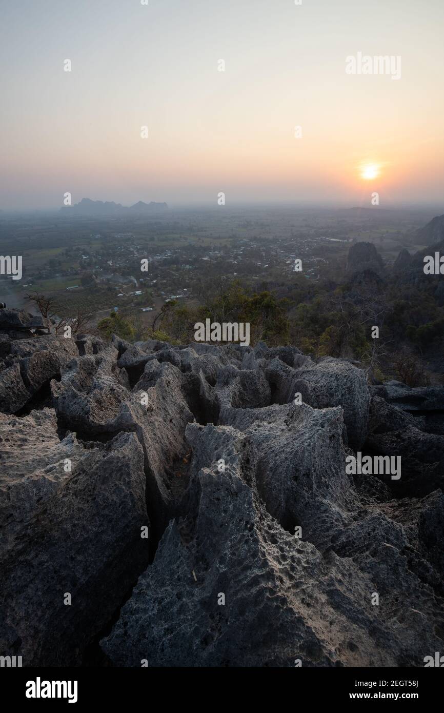 This is the photo of limstone mountain in Pisanulok Thailand during Sunset in rural area, the view is from the top of mountain. Stock Photo