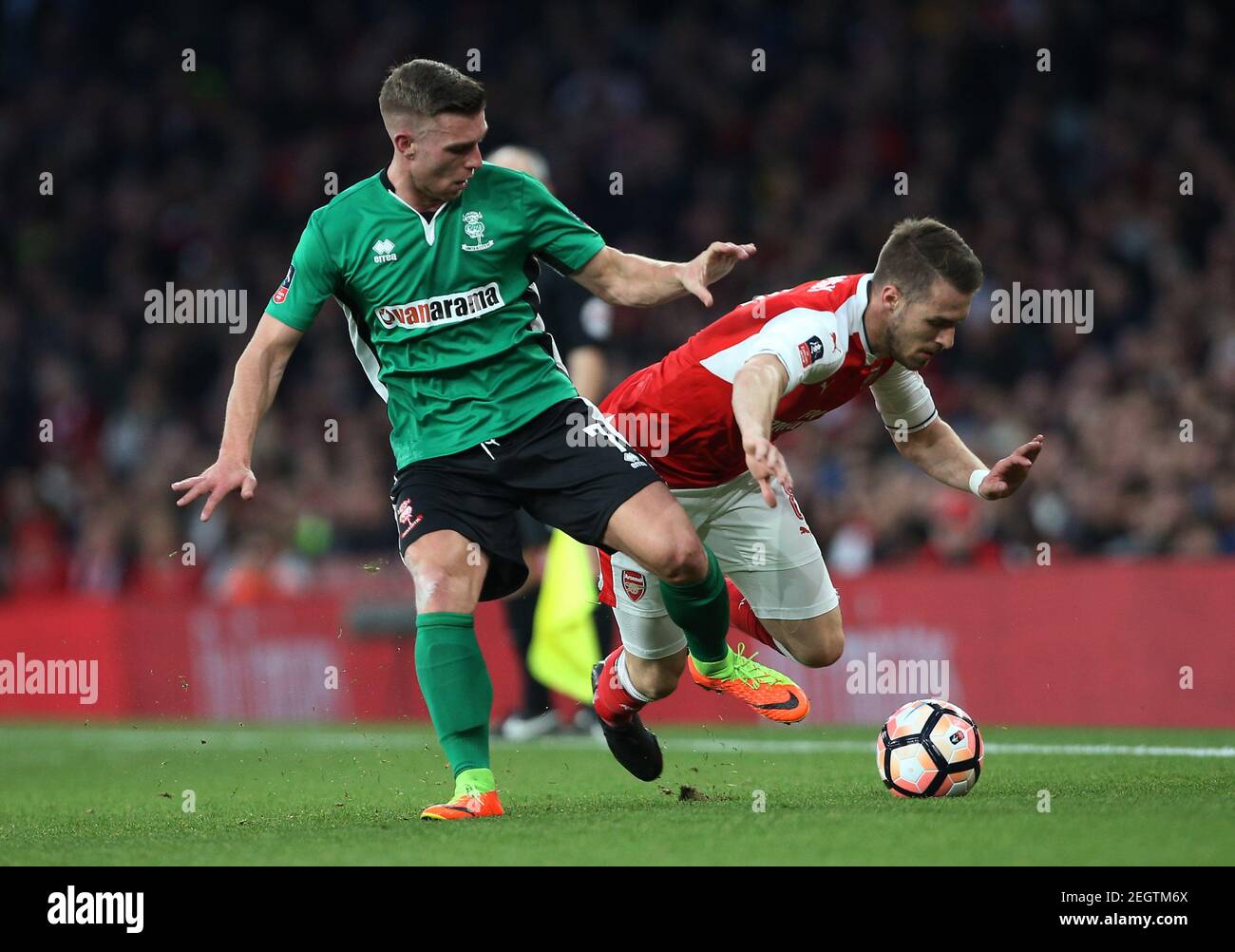 Britain Football Soccer - Arsenal v Lincoln City - FA Cup Quarter Final - The Emirates Stadium - 11/3/17 Lincoln's Jonathan Jack Muldoon  in action with Arsenal's Aaron Ramsey  Reuters / Paul Hackett Livepic EDITORIAL USE ONLY. No use with unauthorized audio, video, data, fixture lists, club/league logos or 'live' services. Online in-match use limited to 45 images, no video emulation. No use in betting, games or single club/league/player publications.  Please contact your account representative for further details. Stock Photo
