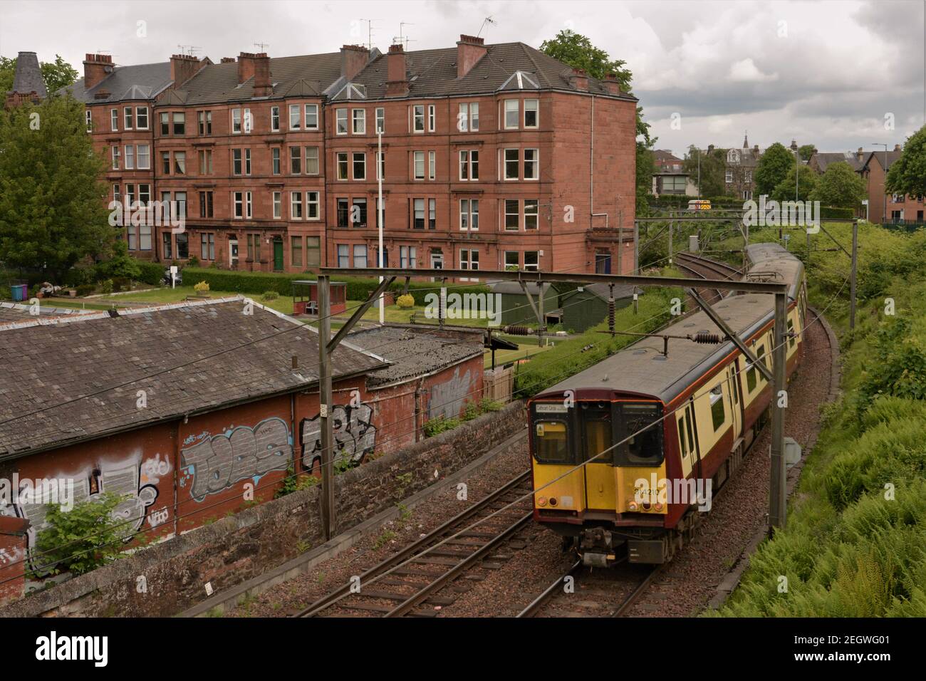 Scotrail 314210 passes Hampden Bowling Club as it heads for Mount