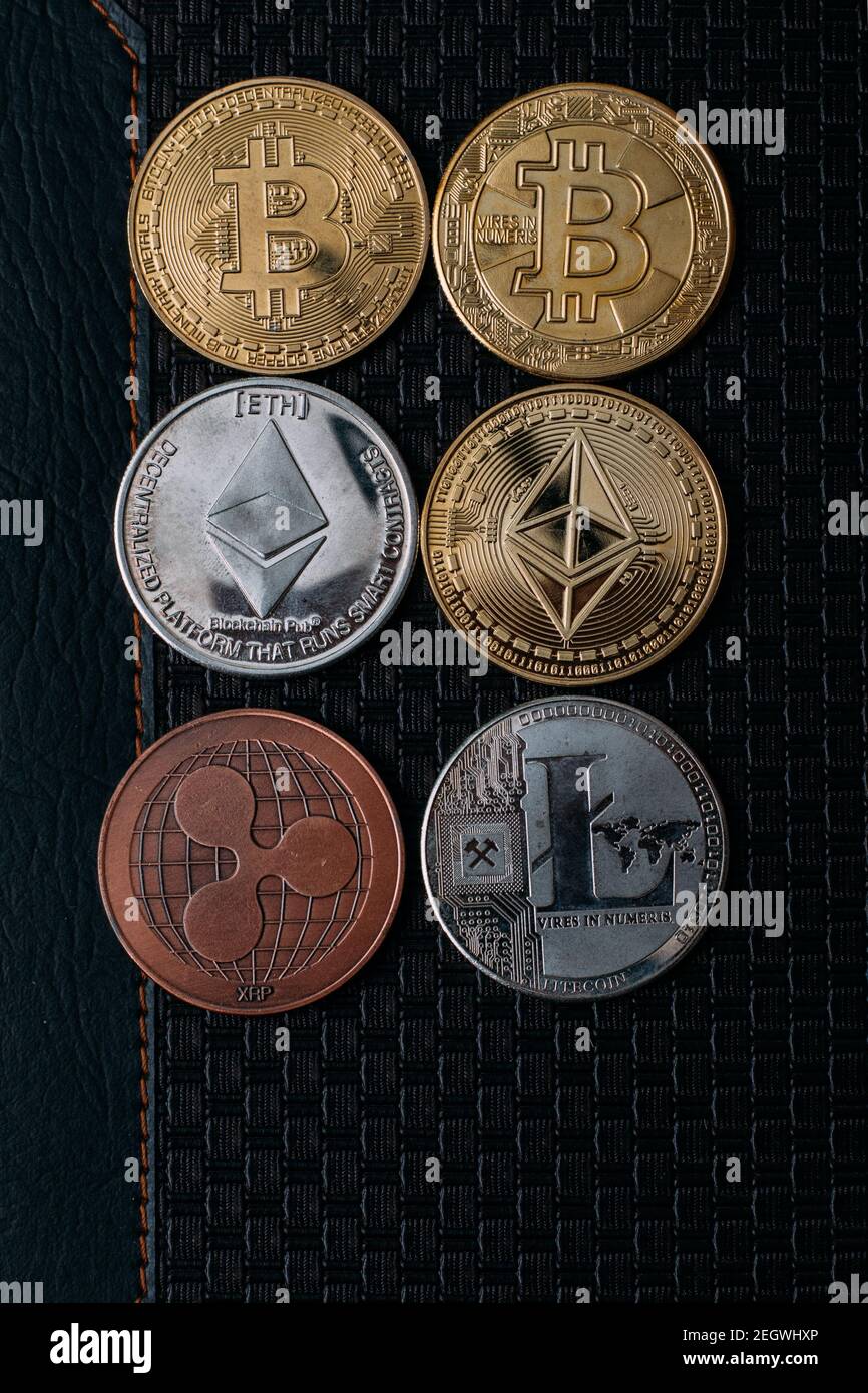 Different coins of crypto currency on a black background. Business concept  Stock Photo - Alamy