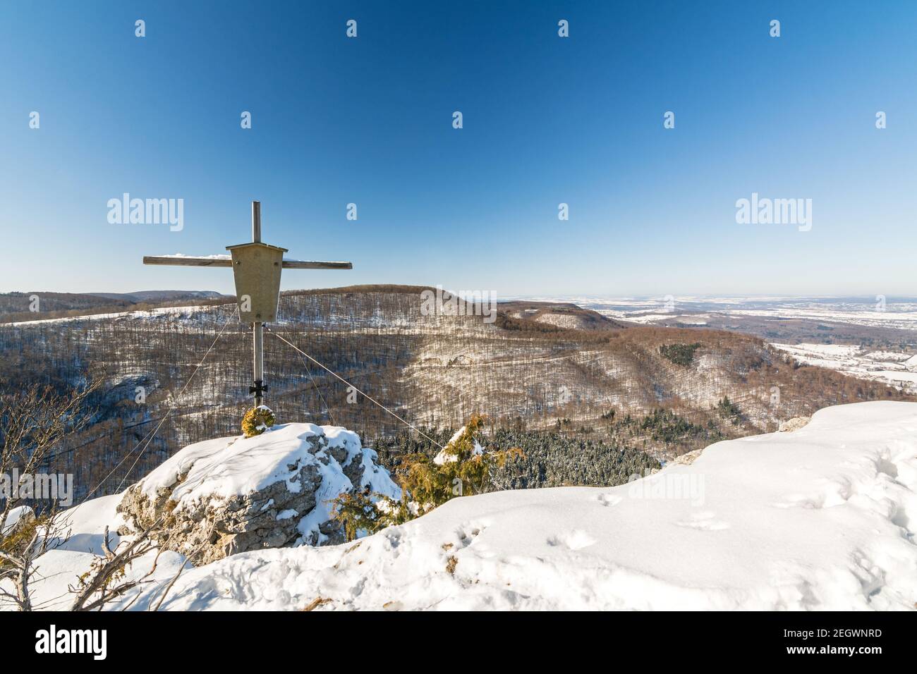 Summit cross on a mountain peak in a beautiful winter landscape in the Swabian Alps Stock Photo