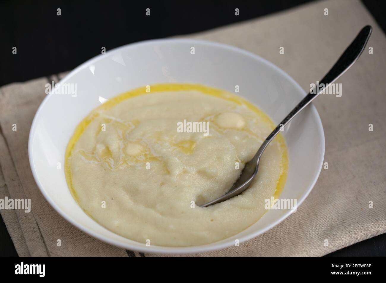 Semolina porridge or wheat cream in white plate with milk and butter.  Breakfast is ready Stock Photo - Alamy