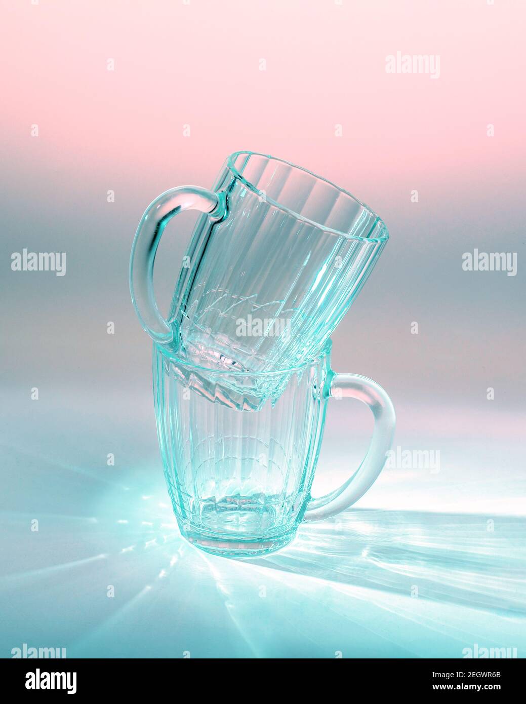 two empty beer glasses on table in blue and pink light Stock Photo