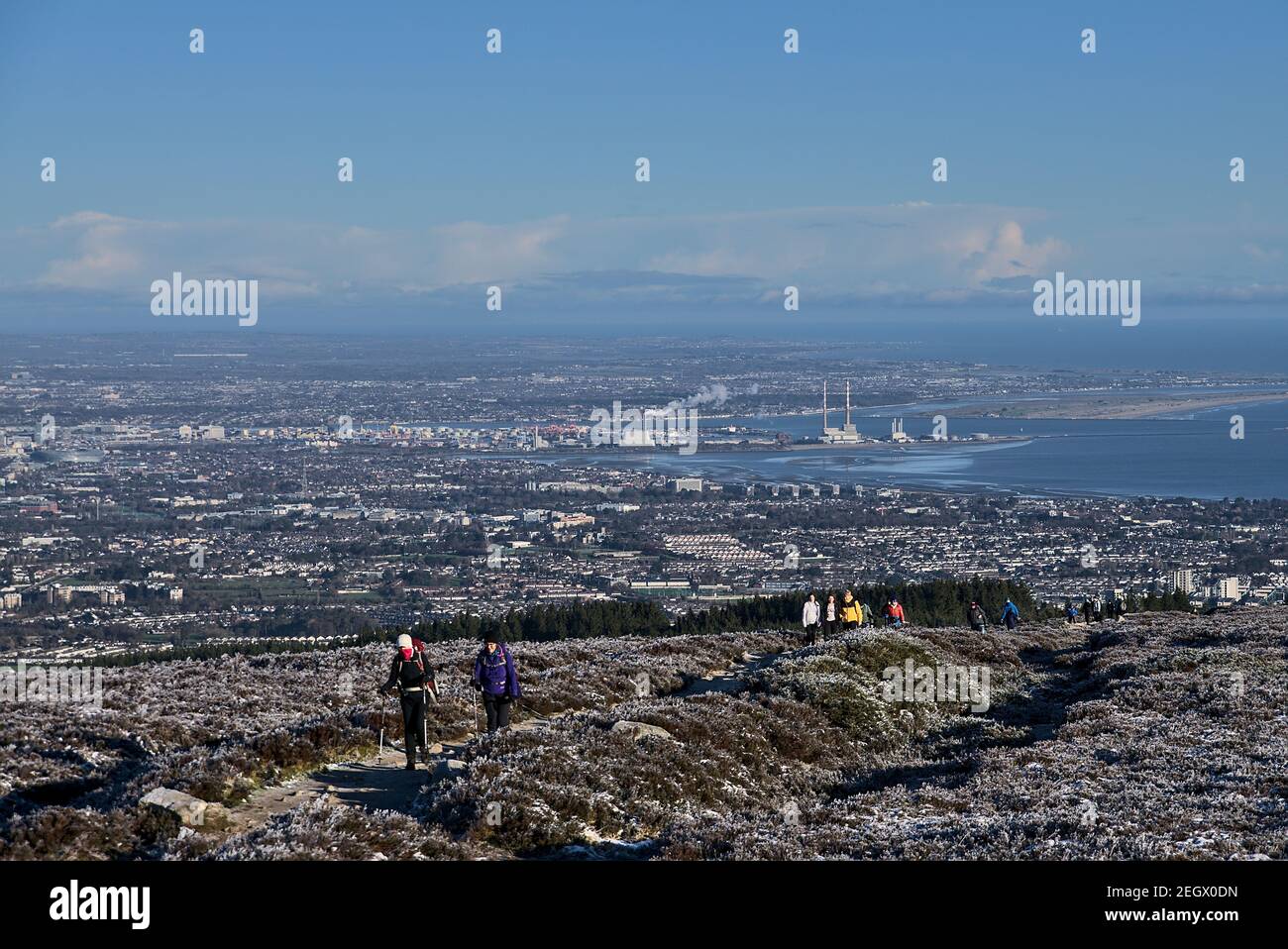 People hiking during coronavirus lockdown to see unusual Irish winter and landscapes of Dublin and Wicklow Mountains. Seen from Fairy Castle (Two Rock Stock Photo