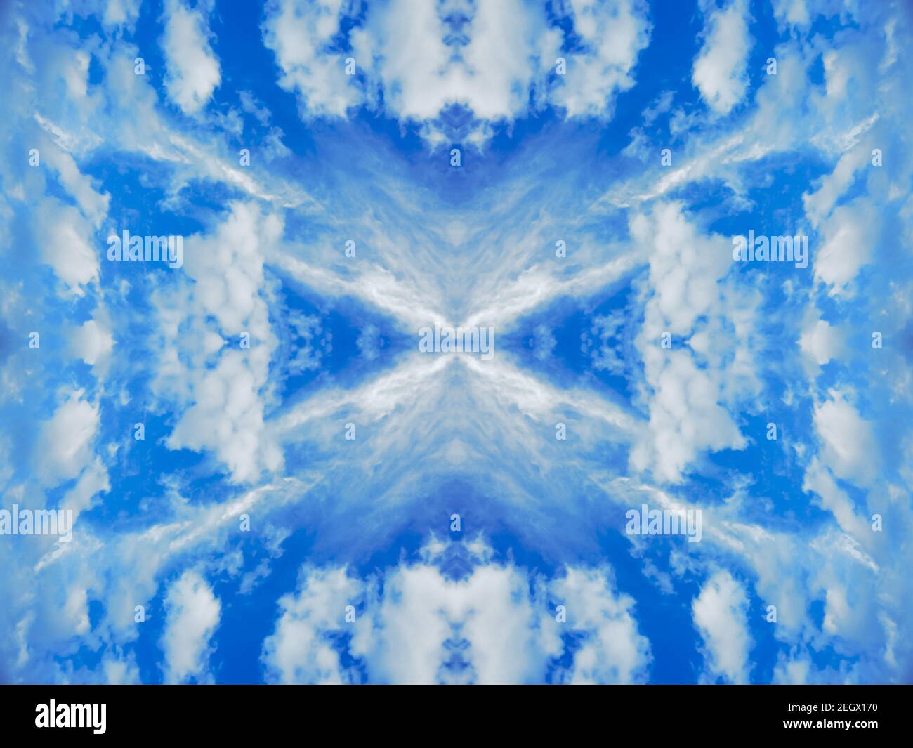 Blue sky with white clouds. Mirror reflection, symmetric pattern. Blurred textured background with kaleidoscope effect. Abstract natural wallpaper Stock Photo