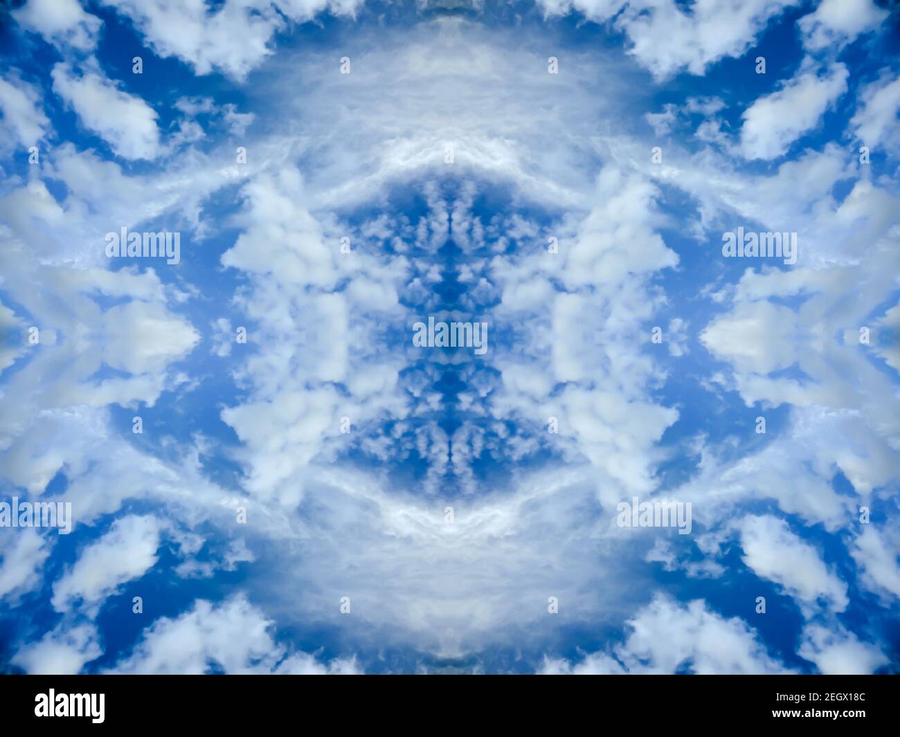 Blue sky with bright clouds. Mirror reflection, textured background with kaleidoscope effect. Abstract natural wallpaper Stock Photo