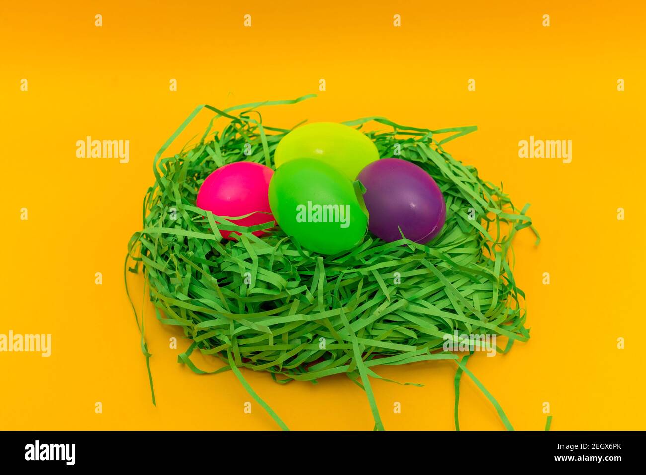 Four Colorful Easter Eggs Sitting in Green nest or Grass.Studio image. Stock Photo