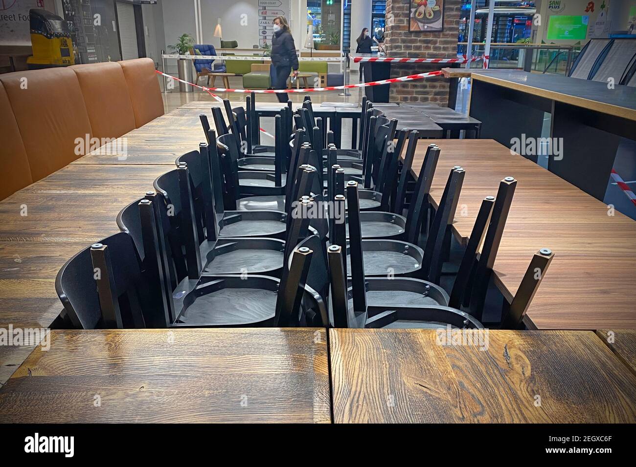 Munich, Deutschland. 19th Feb, 2021. Closed catering business, empty tables  and chairs are put together and stacked on top of one another. Gastronomy  is threatened by the corona pandemic. Closed catering business,