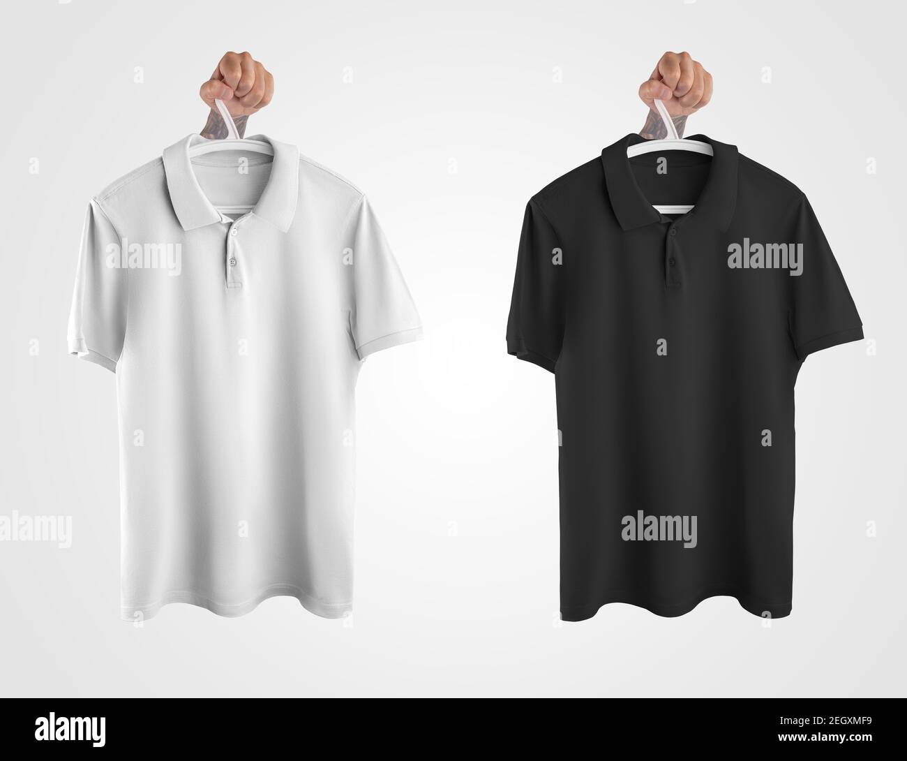 Mockup of white, black polo hanging on a hanger in hand, clothes for men, isolated on background. Template for a branded t-shirt with a collar, for de Stock Photo