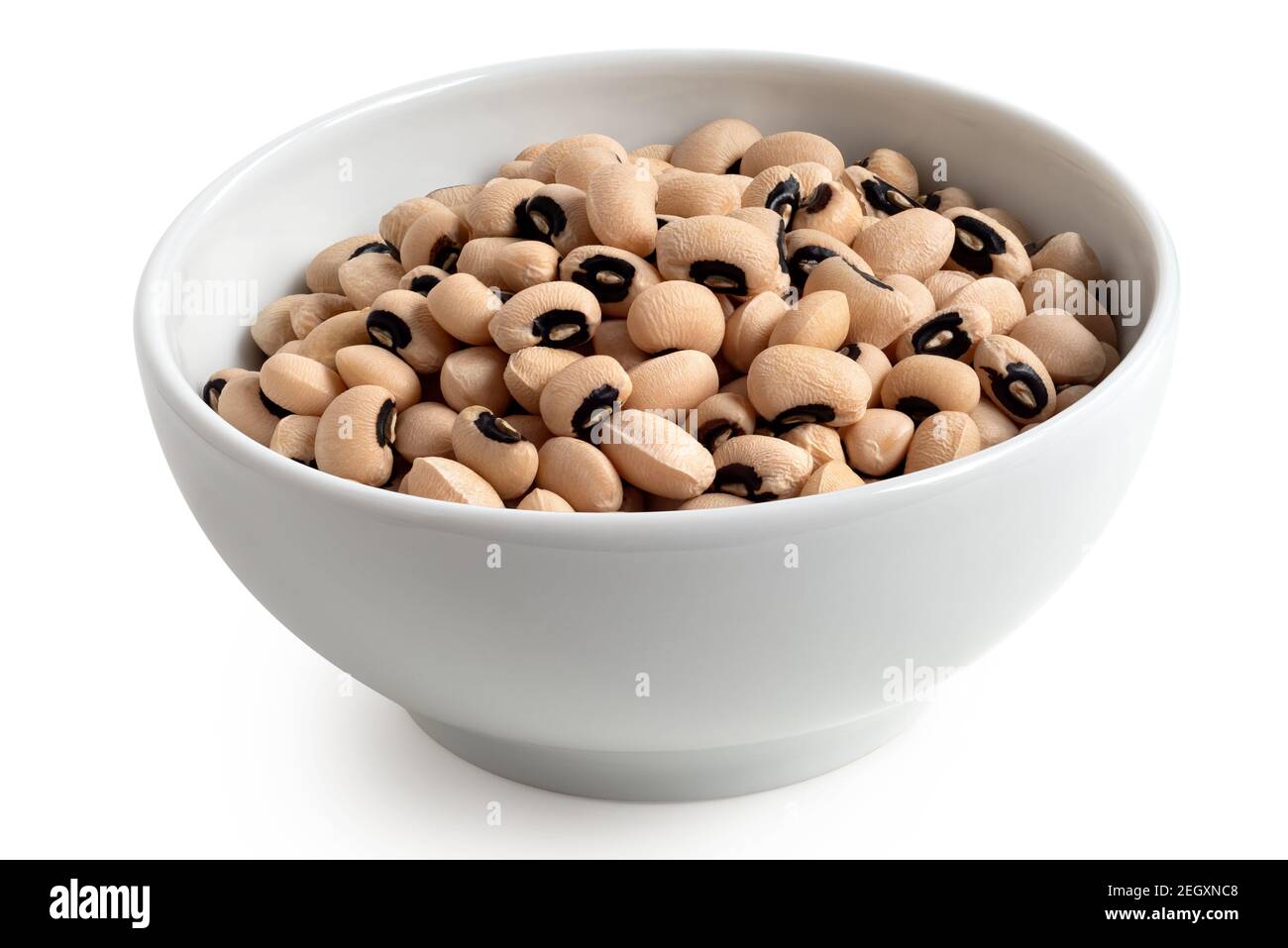 Uncooked black-eyed beans in a white ceramic bowl isolated on white. Stock Photo