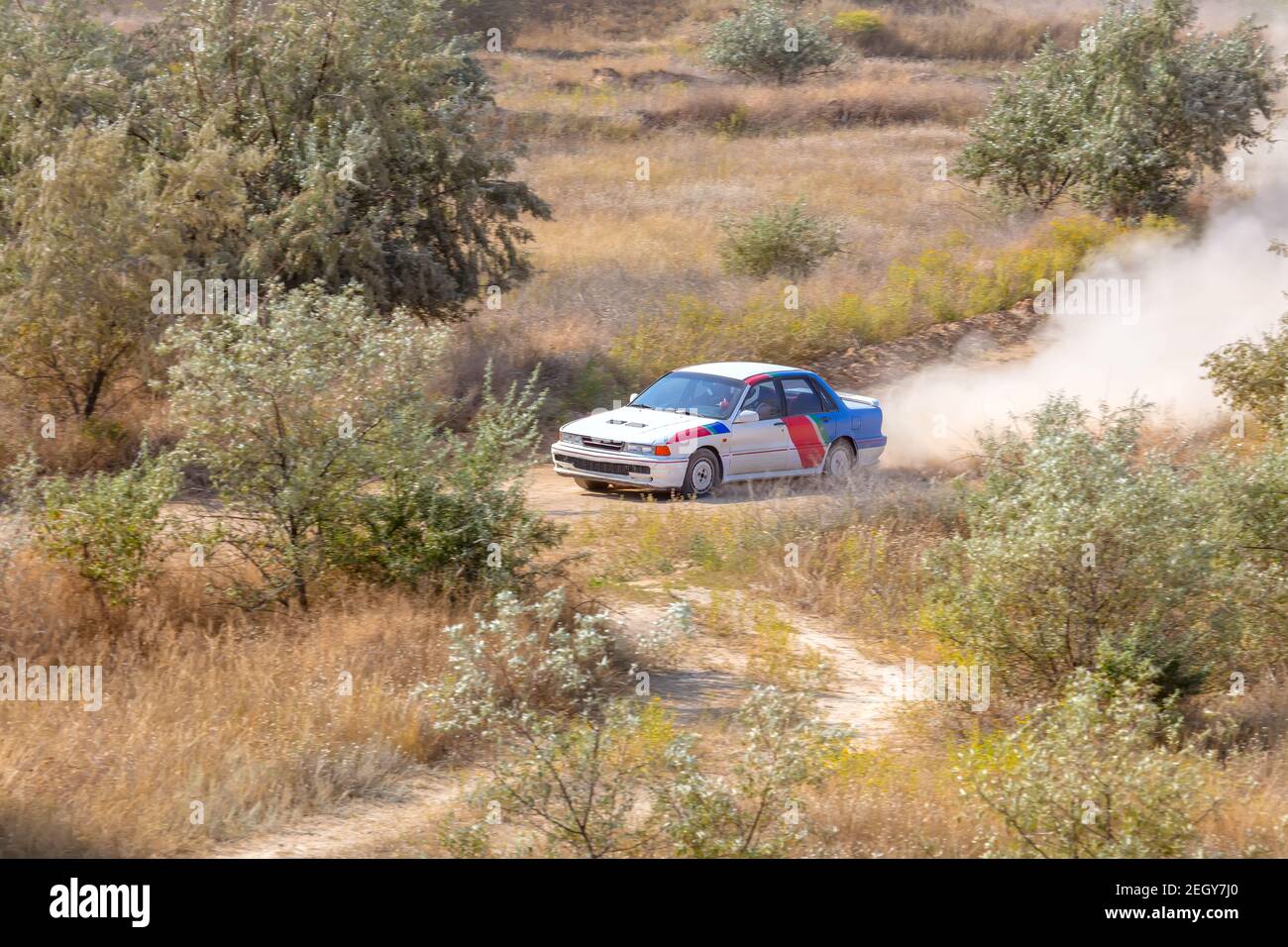 Sunny summer day. Dusty rally track. Sports car does a lot of dust in turn 04 Stock Photo