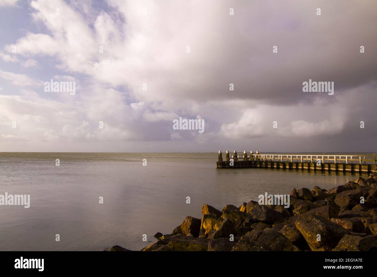 Afsluitdijk, a dam separating the North Sea from the Ijsselmeer lake. View from bridge at Breezanddijk, an artificial island created by building the Stock Photo