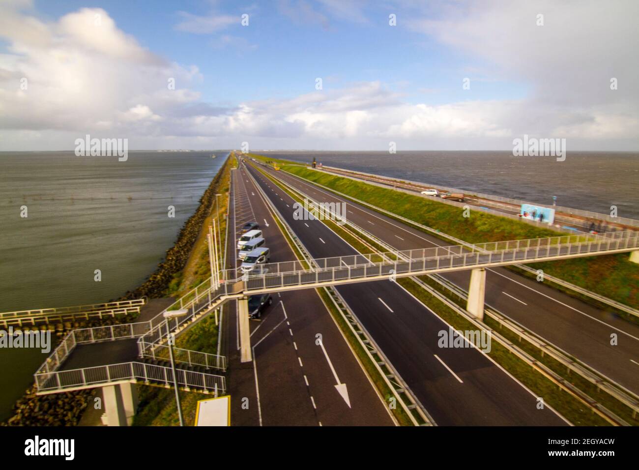 Motorway A7 on Afsluitdijk, a dam separating the North Sea from the Ijsselmeer lake. View from bridge at Breezanddijk, an artificial island created by Stock Photo