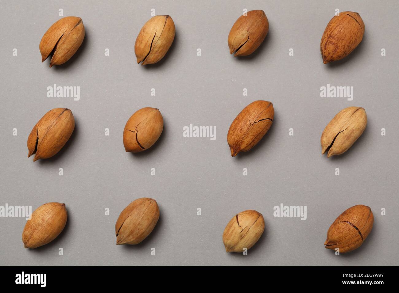Flat lay with tasty pecan nuts on gray background Stock Photo