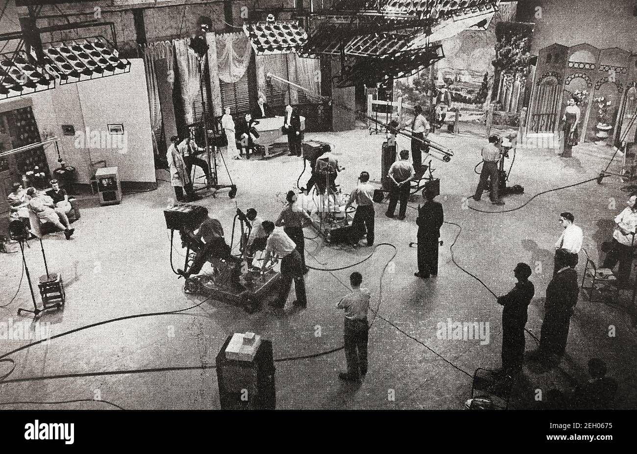An early printed photograph showing 4 separate sets being filmed simultaneously at the former BBC Lime Grove  television Studios, Shepherds Bush , London, UK.   The complex  had been built originally   by the Gaumont Film Company in 1915. It was used by them and by Gainsborough Pictures. The BBC  used it for television broadcasts until 1991 including the filming of  Steptoe and Son; Doctor Who; Nationwide; Top of the Pops; and The Grove Family (named after the studio). It was demolished in 1993 Stock Photo